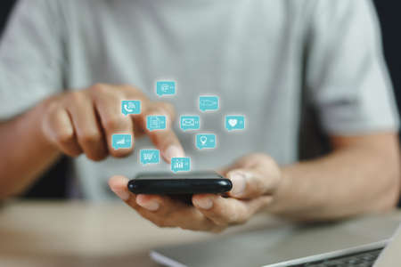 man touching mobile phone or smartphone with notification social media icons, email, shopping,...