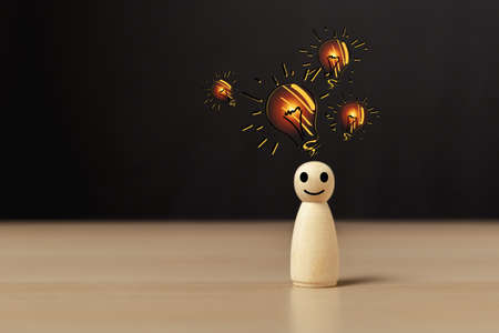 Wooden doll people human women standing with light bulb icon idea, intelligent think power, creative...