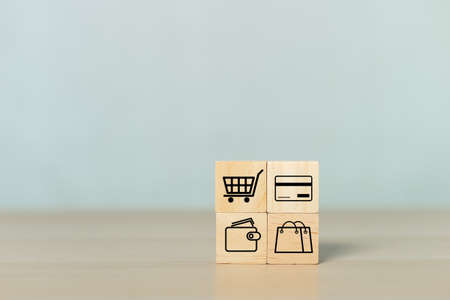 Concept of online shopping. wooden cube blocks with shopping or e-commerce icons on table. business online marketing.の写真素材