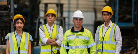 Team engineering, worker standing at warehouse auto parts. industry factory car automobile. Teamwork technician work successful, connection partnership successful concept.の写真素材