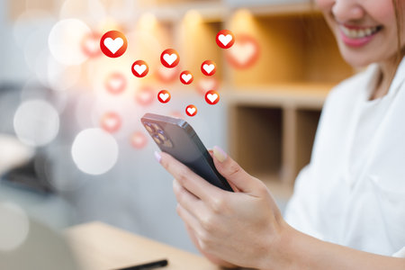 woman using smartphone with love button icons. Online digital communication connection information...