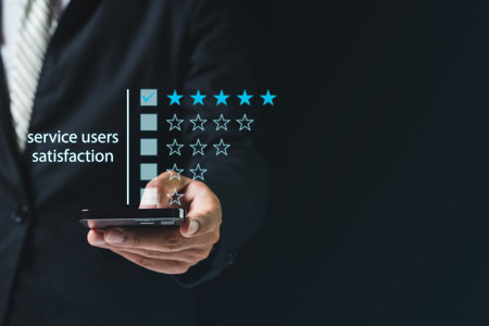 Satisfaction from service users concept. businessman using smartphone finger point customer satisfaction check star rating black background, person click button or touch pointing.の写真素材