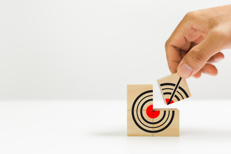 Connection partner to goal concep. Hand holding wooden cube block connect goal icon white background. Partner business growth success. Vision teamwork corporate leading to progress. Copy space.の写真素材