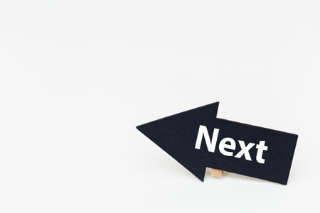 Word text NEXT on blackboard arrow white background. growth symbol, vision idea goal.の写真素材