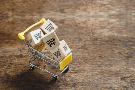Wooden cubes block with shopping cart icons in shopping cart, sell marketing purchase delivery. Online shopping concept.の写真素材