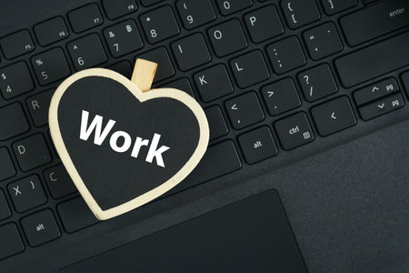 Word work text on heart-shaped blackboard on laptop keyboard. business concept.