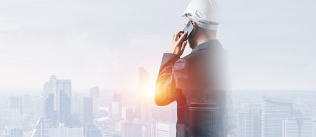 Man engineer talking telephone overlay with building architecture urban cityscape. creation city communication concept.の写真素材