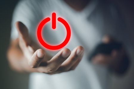 Red power button icon on hand. control open and close. man use control energy. save space electric symbol.の写真素材