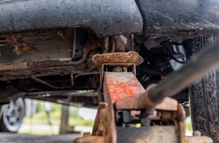 Hydraulic car jack,  maintenance service car garage Car mechanic using jack to repair suspension. Automobile service.の写真素材