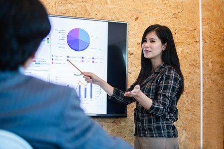 Asian young businesswoman presentation pointing digital board in meeting boardroom. brainstorming...