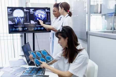 Female medical student study in class room. medical students studying human brain disease diagnosis through learning from X-ray film. Learn about brain surgery for diagnosis.の写真素材