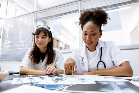 Female medical student study in class room. medical students studying human brain disease diagnosis through learning from X-ray film. Learn about brain surgery for diagnosis.の写真素材