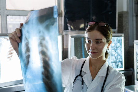 Doctor woman looking check up x-ray film in medical laboratory at hospital. Anatomy diagnostic science of human.の写真素材