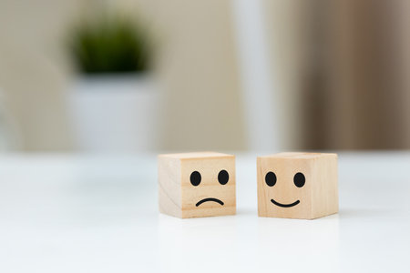 Rating and satisfaction concept. Wooden block with happy and unhappy face. feedback choice of marketing. Symbol of business partner selection.の写真素材