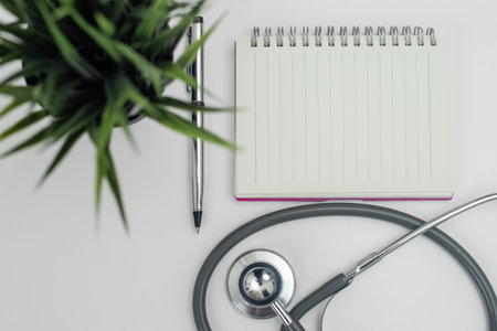 Blank notebook with stethoscope white background. heart and healthcare concept. diagnostic, disease, cardiology. equipment research of physician for treatment patient.の写真素材