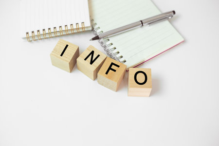 Abbreviation of INFO on wood cube block note book on white table. Analysis Information strategy...