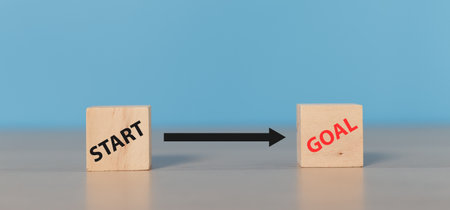 wood cube with text start and goal, challenge planning vision marketing performance inspiration.
