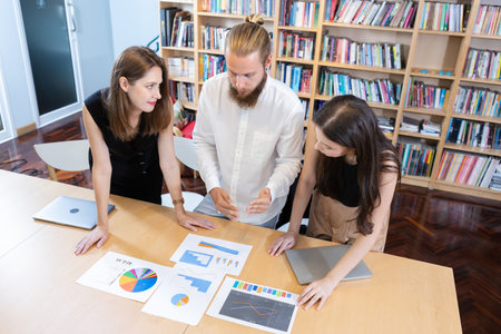 Group of business people brainstorming at table to work. Effective people in organization use idea to consult their work. employees drive company.の写真素材