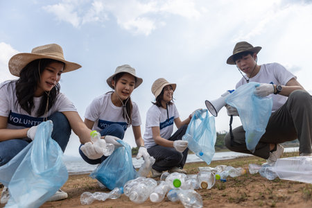 Group of volunteers holding rubbish bags. clean up plastic garbage in tourist attractions. Conservation and care cleanliness in nature.の写真素材