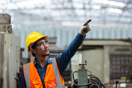 asian engineering worker man wearing uniform safety and hardhat working machine lathe metal in...
