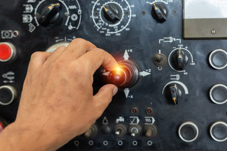 à¹Hand of engineer turn power button on panel control machine. mechanic's hands Pressing the work button. Engineering are working on turning on machines in industrial plants.の写真素材
