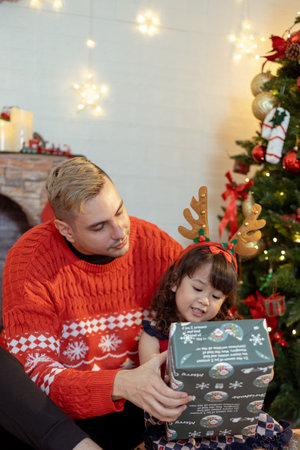 Happy father and little girl daughter celebration surprise christmas gifts box. Christmas and holidays concepts. family, christmas, x-mas.の写真素材