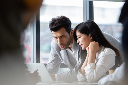 Man leader teaching work analyzing project in company for female employees. Male manager training work for women in corporate. checking work. Teamwork concept.の写真素材