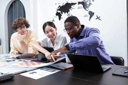 Teamwork architects designers brainstorm modern office an using laptop with blueprint on table. Team...