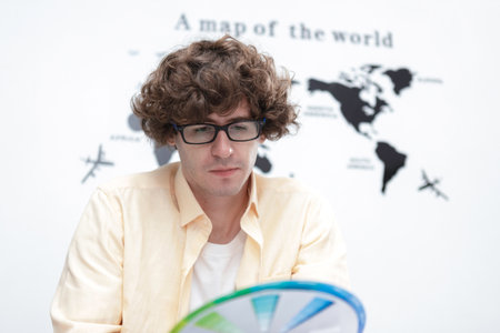 young caucasian man creative graphic designer selecting color swatch samples idea at modern office....