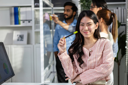 Portrait businesswoman standing at modern office looking at camera. business professional or support partnership. Successful happy asian female smiling.の写真素材
