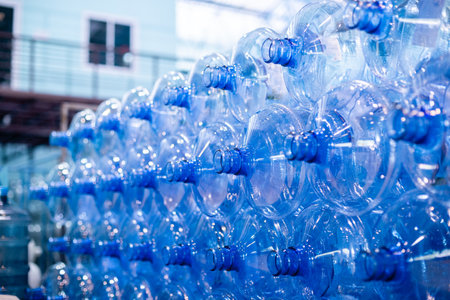 Plastic bottle for drinking water in production line of factory. Process of filling water into...