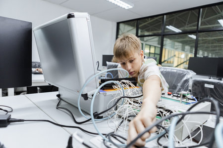 students boy learning to repair electrical appliances. education on table at class room, Robotics learning innovation. electric system skill training. STEM education concept.の写真素材