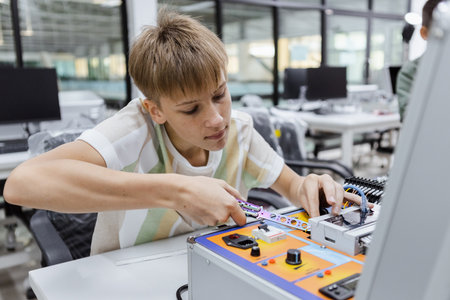Boy learning to repair electrical appliances. education on table at class room, Robotics learning...