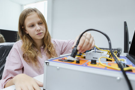 Happy girl education electronic on table at class room. learning innovation electronic for future AI. System skill training. STEM education concept.の写真素材