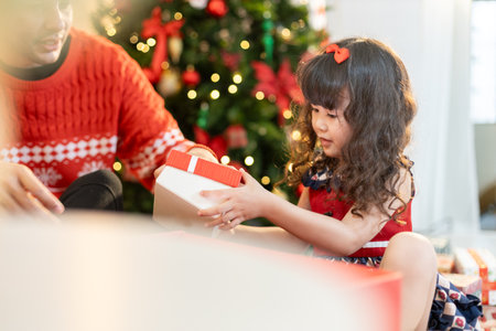 Happy father and little girl daughter celebration surprise christmas gifts box. Christmas and holidays concepts. family, christmas, x-mas.の写真素材