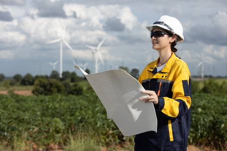 Female engineer wind turbine worker survey operational planning windmill clean renewable energy technology for future. Alternative technology protect environment reduce global warming problems.の写真素材