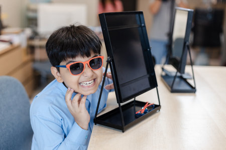 Happy child boy wearing sunglasses in glasses shop.の写真素材