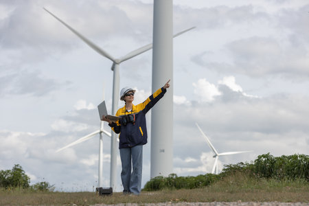 Female engineer wind turbine worker survey operational planning windmill clean renewable energy...