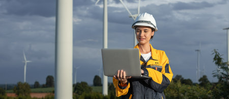 Female engineer wind turbine worker survey operational planning windmill clean renewable energy technology for future. Alternative technology protect environment reduce global warming problems.の写真素材