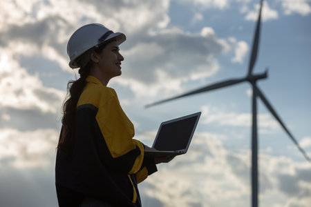 Renewable energy systems concept, engineer female using laptop working wind turbine for alternative energy, Technology protect environment reduce global warming problems.の写真素材