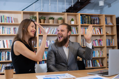 Two businesspeople men and women look cheerful. Glad to experience success of meeting working. Successful connection and partnership.の写真素材