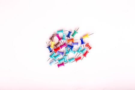 colorful push pins set with shadows isolated on whiteの写真素材