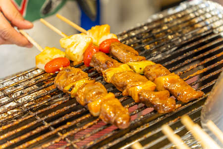 Barbecue skewers, kebabs and vegetables on the grillの写真素材