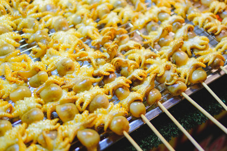 Skewered squid beautifully arranged in a tray