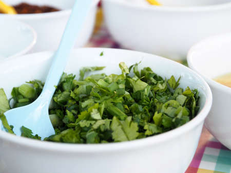 Celery Coriander Cilantro Green Onion sliced mixed in the white cupの写真素材