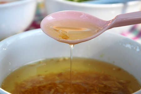 Fried garlic with vegetable oil asian style in white cupの写真素材