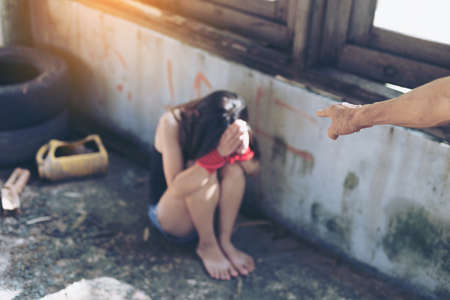 Woman in angle of abandoned building ,focus blur. stop violence against Women, international women's dayの写真素材