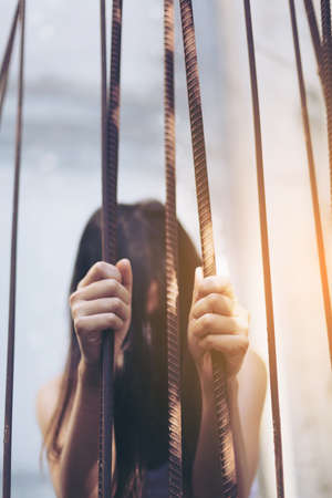 Woman  in angle of abandoned building image blur , stop violence against Women, international women's dayの写真素材