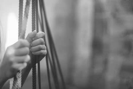 Female Hands with cage cell. trafficking Concept, focus blur.の写真素材