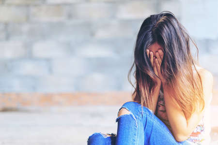 Woman in angle of abandoned building image blur , stop violence against Women, international women's dayの写真素材